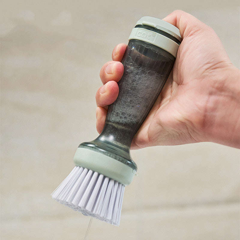 Brush with soap dispenser